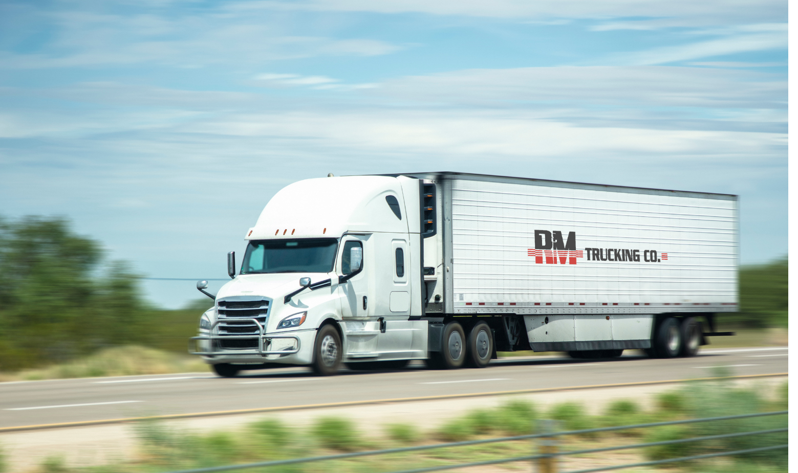 R&M semi driving quickly on a highway